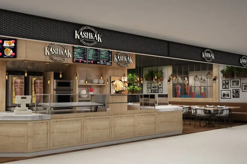 Kashkak Fırın satış alanı, ahşap kaplı banko, menü panoları ve arkada oturma bölümü